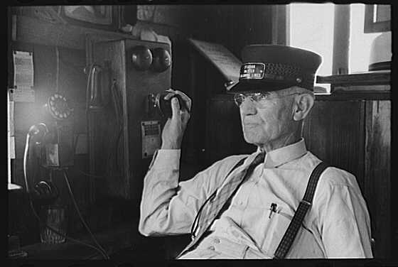 A station manager sits by his phone in this 1939 picture. Courtesy, U.S. Library of Congress 