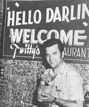 Conway Twitty and a friend pose outside his new restaurant in south Oklahoma City.